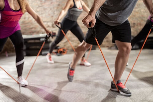 Alcune persone si allenano in palestra con gli elastici