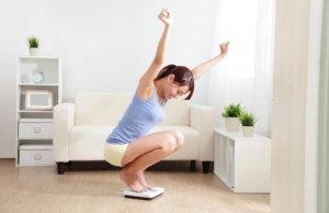 ragazza si pesa sulla bilancia